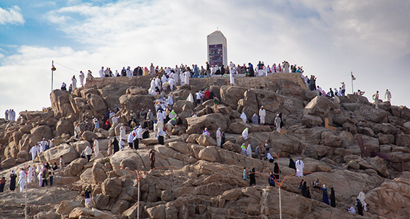 pilgrims a part of Hajj/Umrah climbing Mount Arafat in Mecca